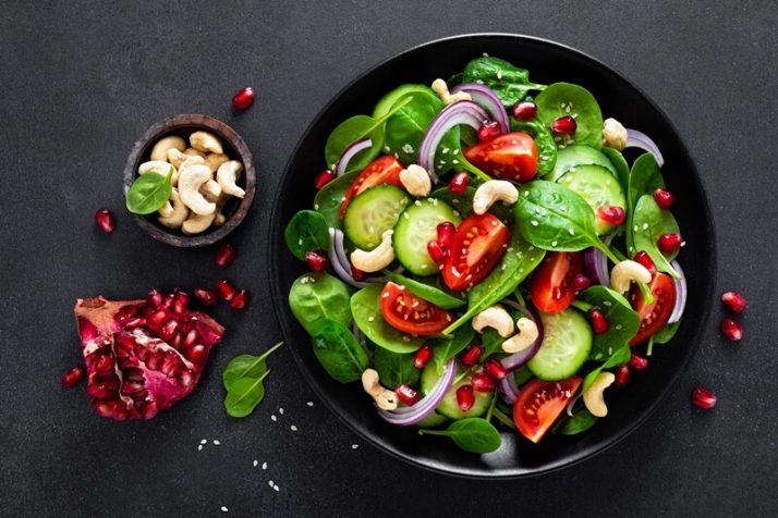 17 Surprising Spinach Nutrition Facts & Health Benefits; Spinach salad with vegetables and nuts