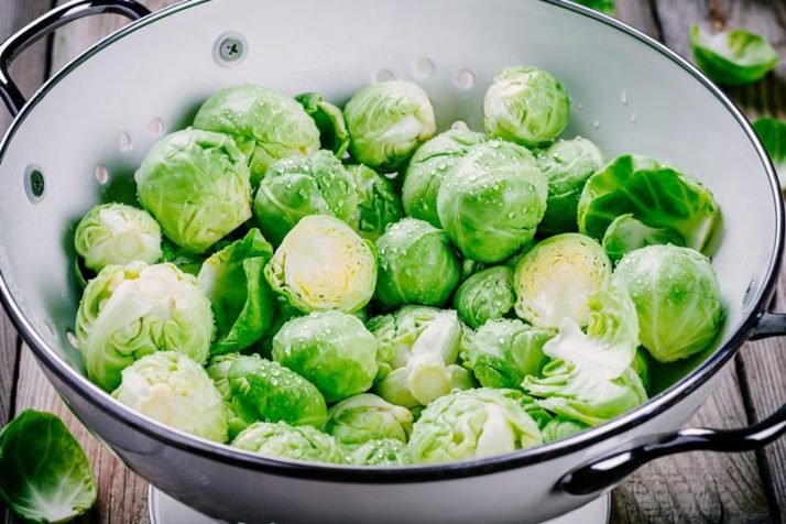 19 Best Plant Based Protein Sources: Complete Whole Foods; Fresh organic Brussels sprouts in a colander on a wooden table