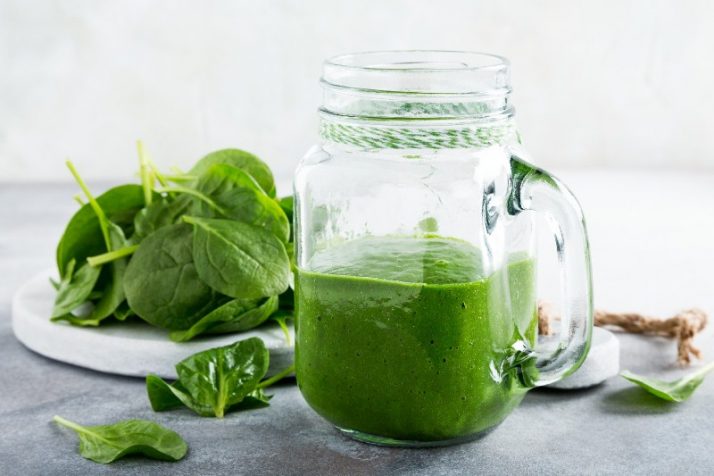 17 Surprising Spinach Nutrition Facts & Health Benefits; Healthy green smoothie with spinach in glass jar