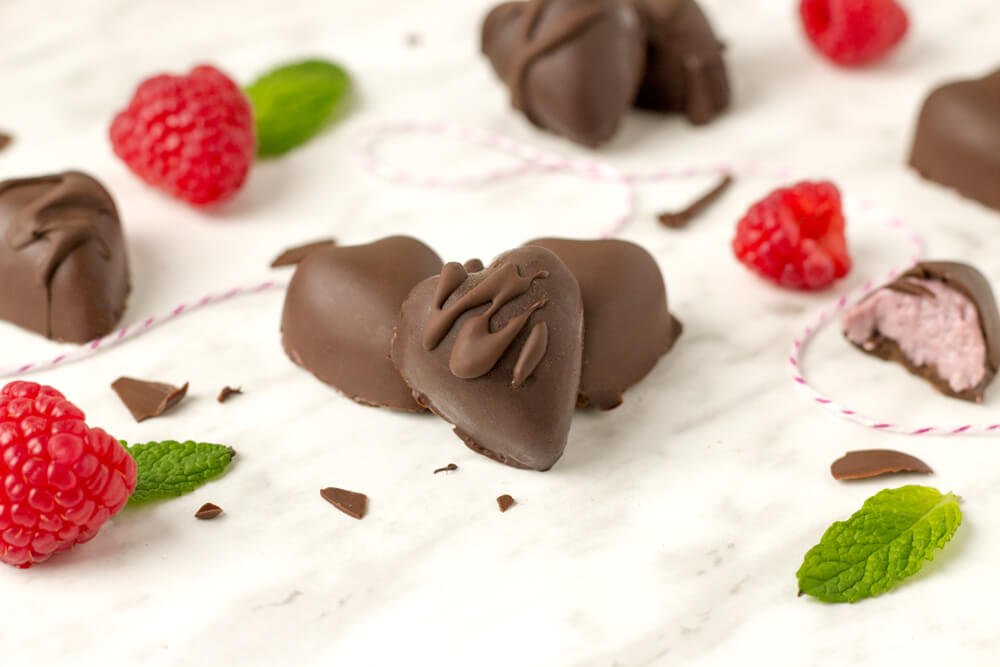 37 Healthy Valentine's Day Recipes: Indulge Without The Bulge 
Creamy Raspberry Filled Chocolates heart-shaped chocolates and raspberries and mint leaves