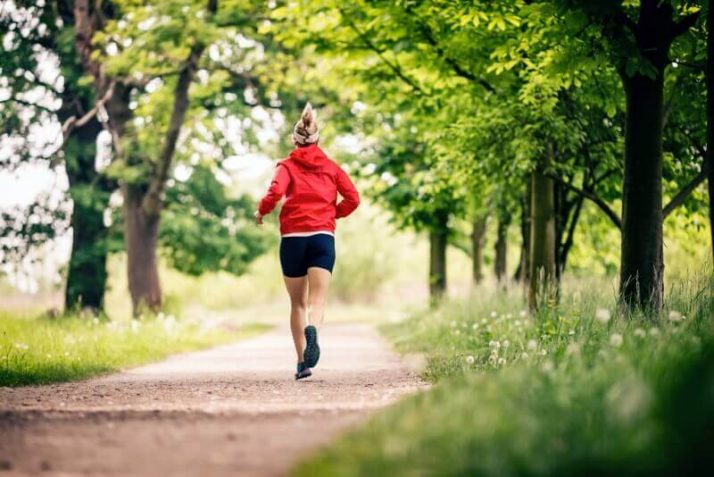 How To Lose Water Weight - 14 Ways To Reduce The Bloat  Running woman, enjoying summer day in park