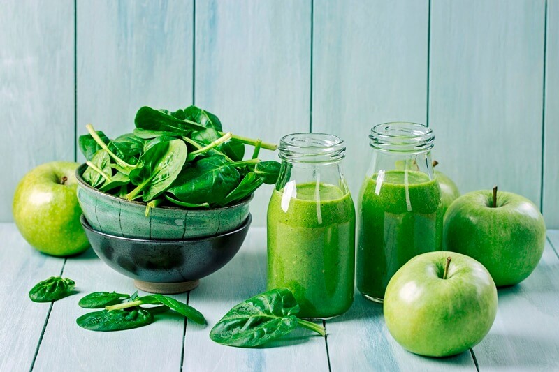 17 Surprising Spinach Nutrition Facts & Health Benefits; Green smoothie with spinach and apples