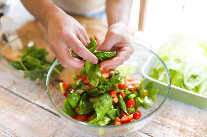 17 Surprising Spinach Nutrition Facts & Health Benefits; Ingredients for salad man holding spinach