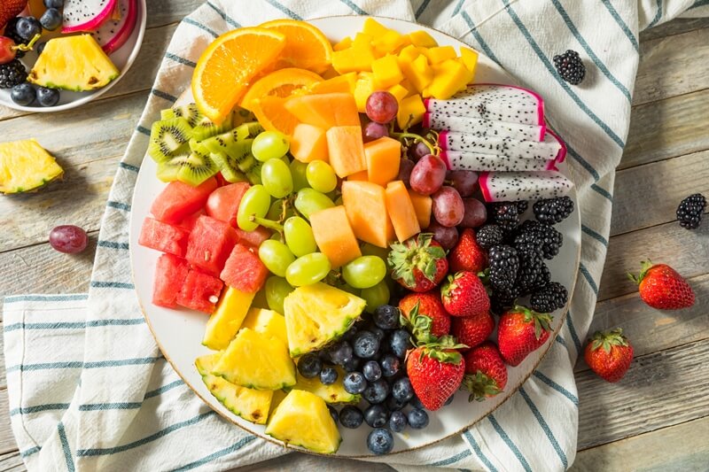 Paleo vs Vegan? Why A Pegan Diet Is Your Best Option; Raw Organic Fruit Platter salad, dragonfruit, berries, grapes, kiwis, watermlon