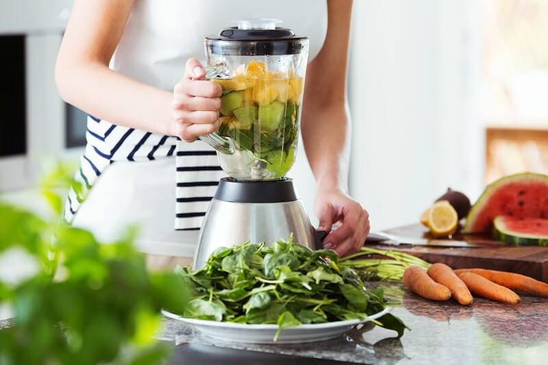 Vegetarian preparing vegan smoothie blender