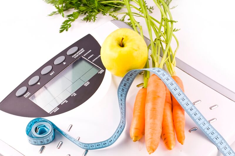 How Many Calories Should I Eat To Lose Weight FAST? carrots, apple and measuring objects scale tape weight loss