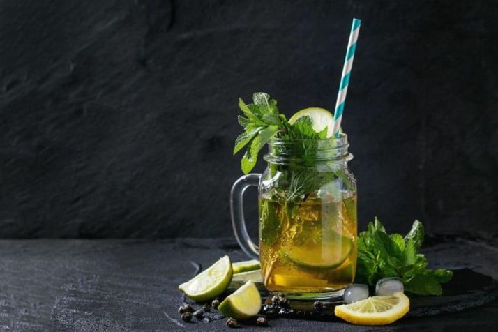 9 Weight Loss Drinks That Work Wonders Ice green tea in a jar with mint and lemon slices