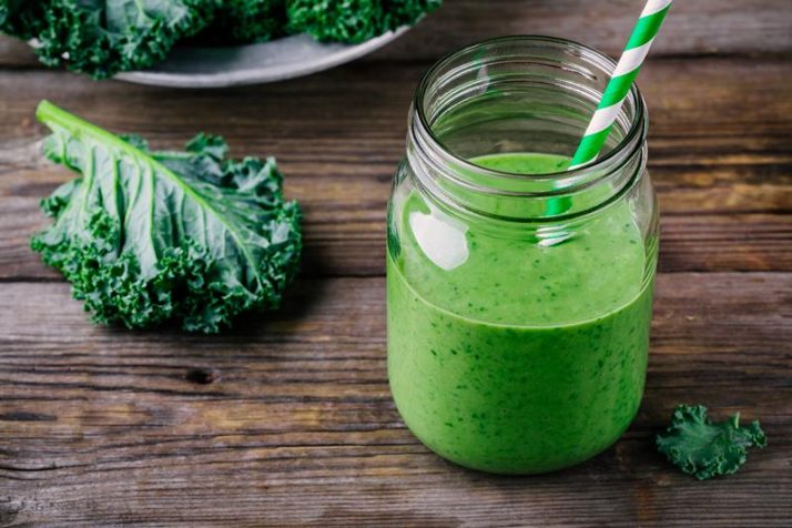 Kale Vs Spinach: We Compare Taste, Health, Protein, Nutrients; Healthy green smoothie with kale in mason jar on rustic wooden background