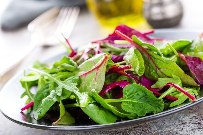 34 High Protein Vegetables You Probably Already Eat; Healthy vegetarian dish, leafy salad with fresh chard, arugula, spinach and lettuce. Italian mix