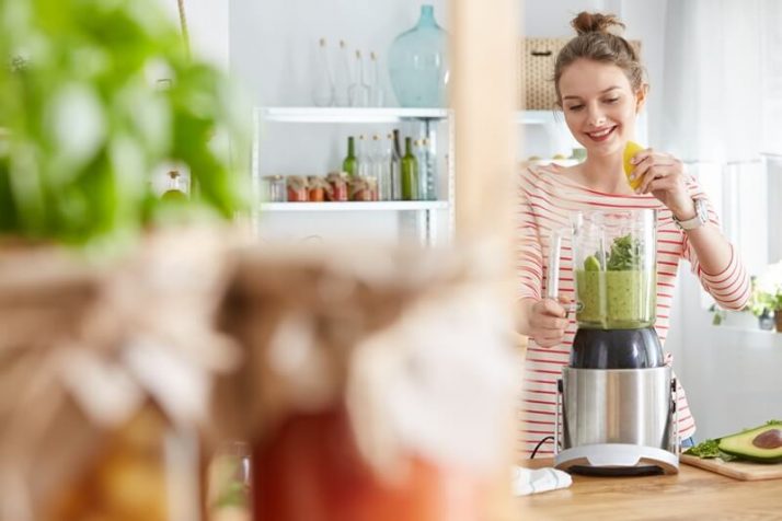 7 Best Blenders For Protein Shakes: To Suit YOUR Needs; Woman making vegetable green smoothie