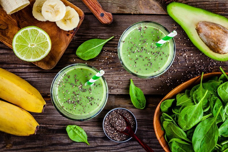 17 Surprising Spinach Nutrition Facts & Health Benefits; healthy green smoothie with banana, lime, spinach, avocado and chia seeds