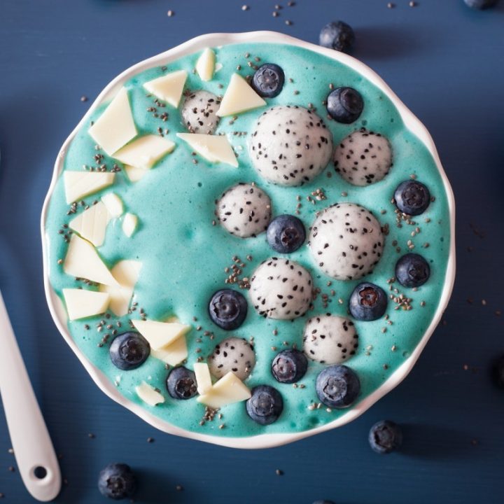 healthy blue spirulina smoothie bowl with blueberry, white choco