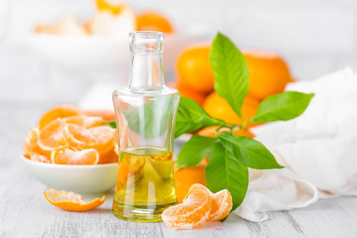 200+ Smoothie Ingredients Shopping List Printable; Tangerines with leaves and bottle of essential citrus oil on a white background