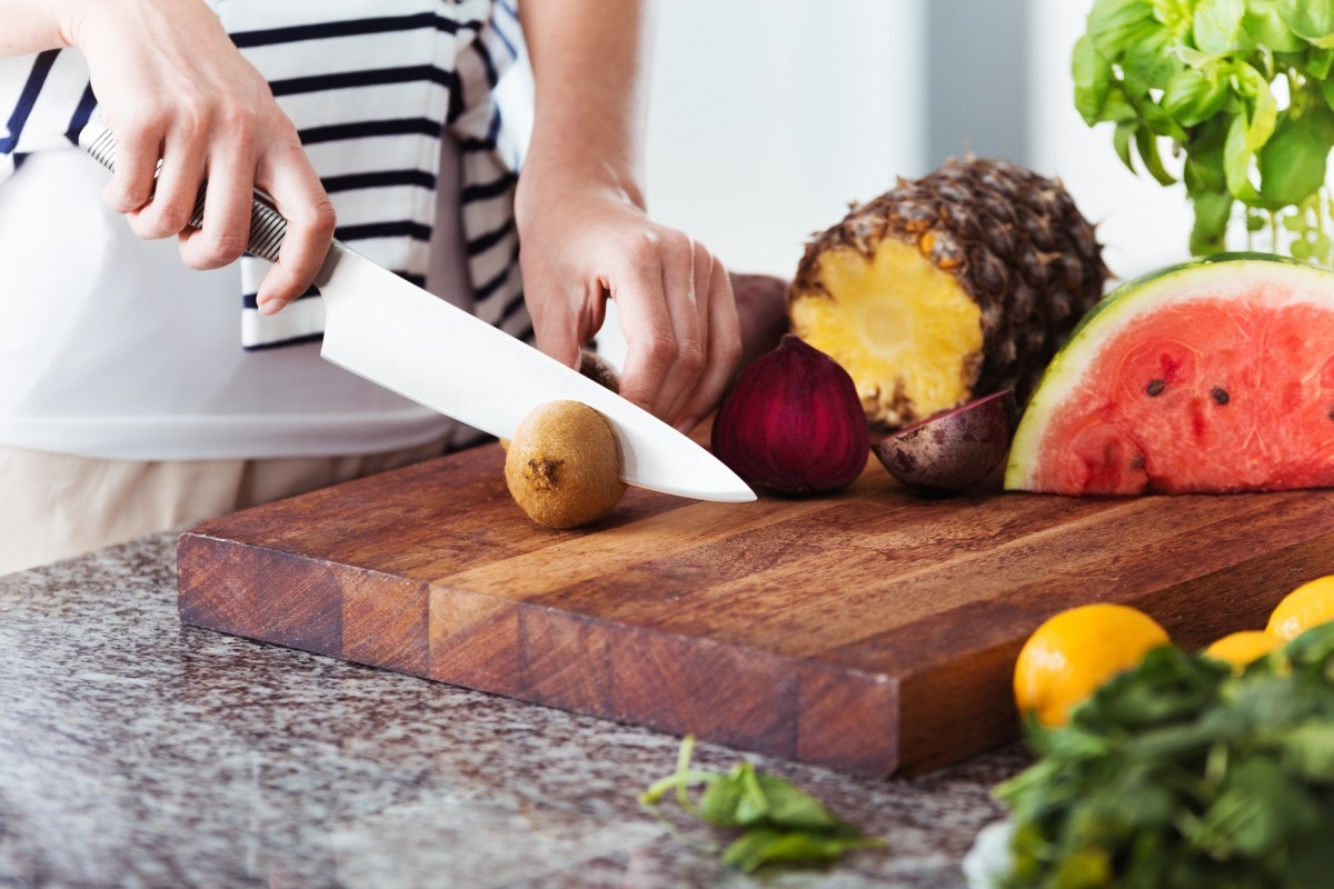 16 Best Smoothie Storage Solutions: My Smoothie Station Ideas; Woman on diet cutting fruit