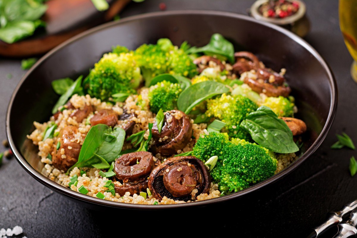 3 Vegetables That Provide ALL Your Essential Nutrients (With Only 450 Calories); Dietary menu. Healthy vegan salad of vegetables - broccoli, mushrooms, spinach and quinoa in a bowl