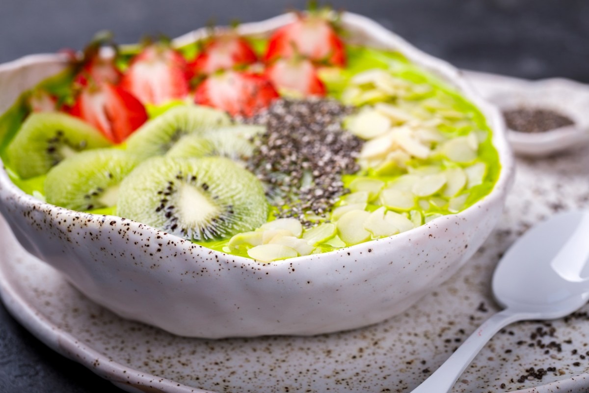 Breakfast Detox Green Smoothie Bowl with fresh berries,kiwi and chia seeds.