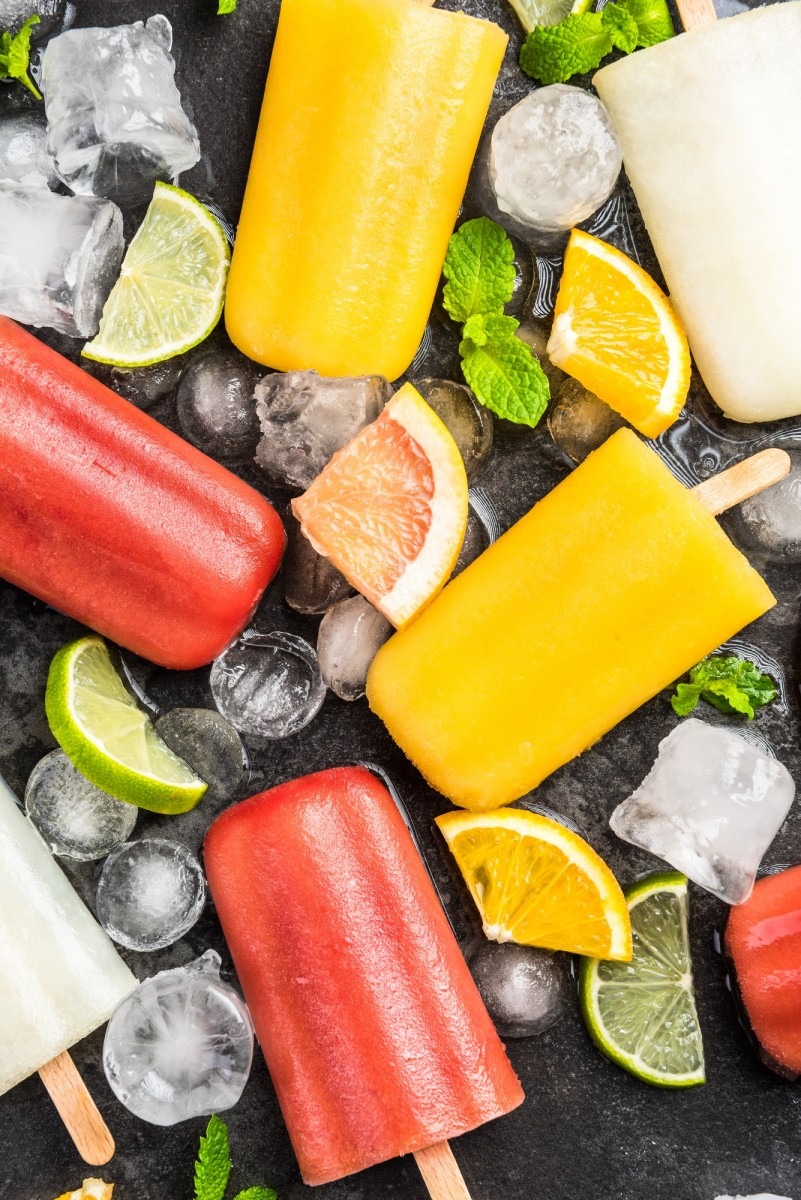 Natural juice homemade healthy popsicles over ice cubes